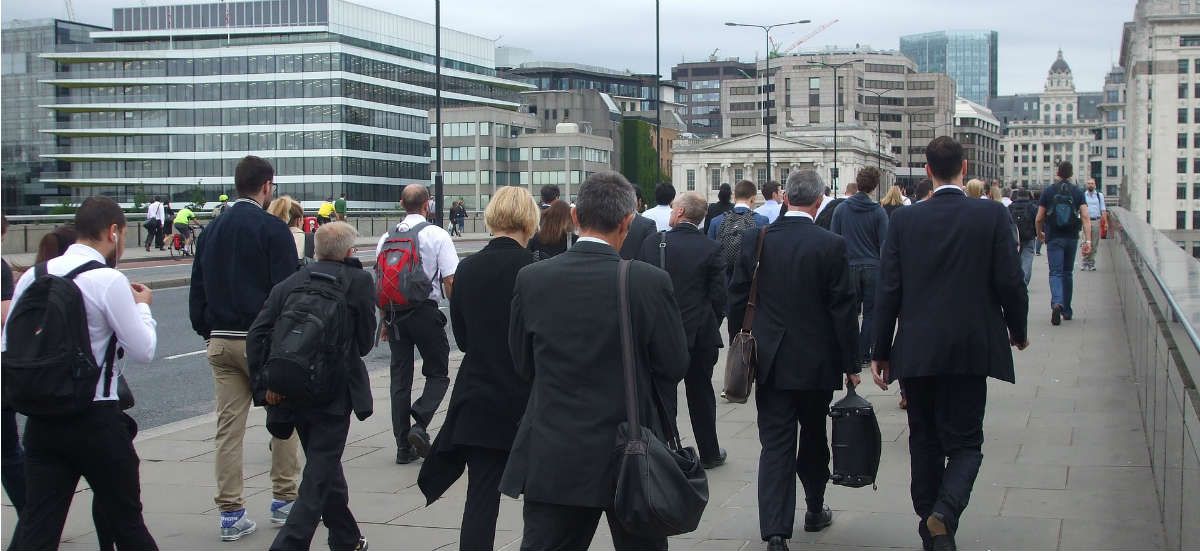 workers in suits crossing a bridge