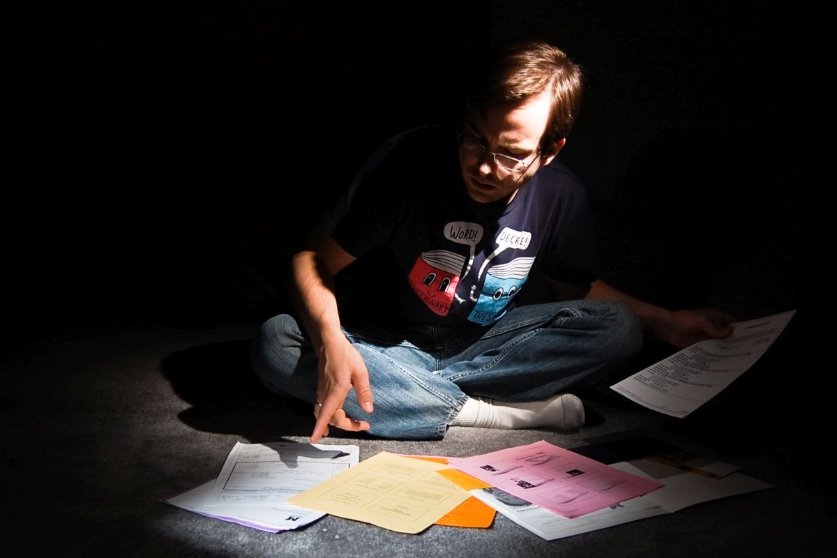 Man in the dark with paperwork
